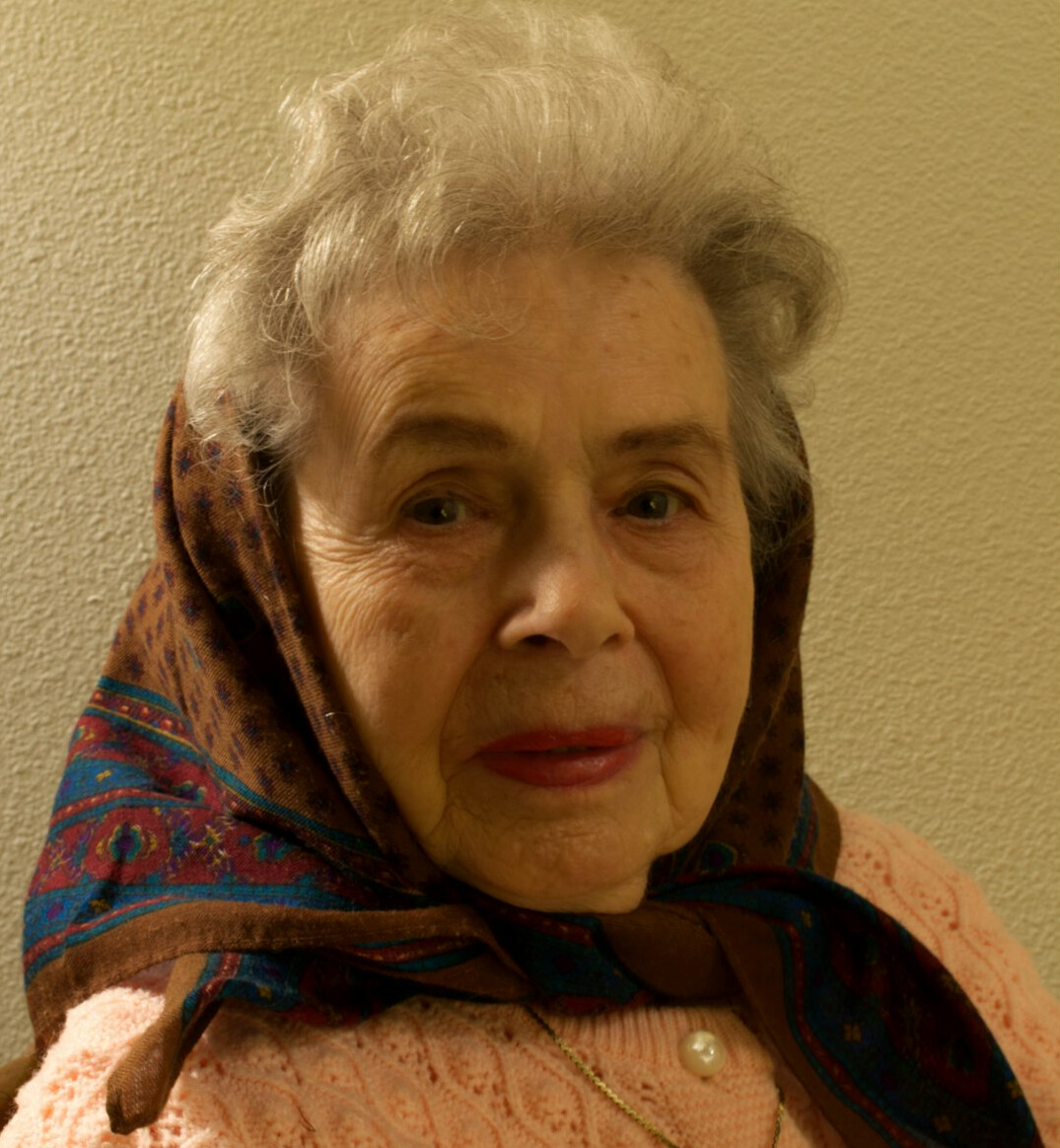 Studio portrait of a Uruguayan woman in her early 50s, historian and researcher, professional attire