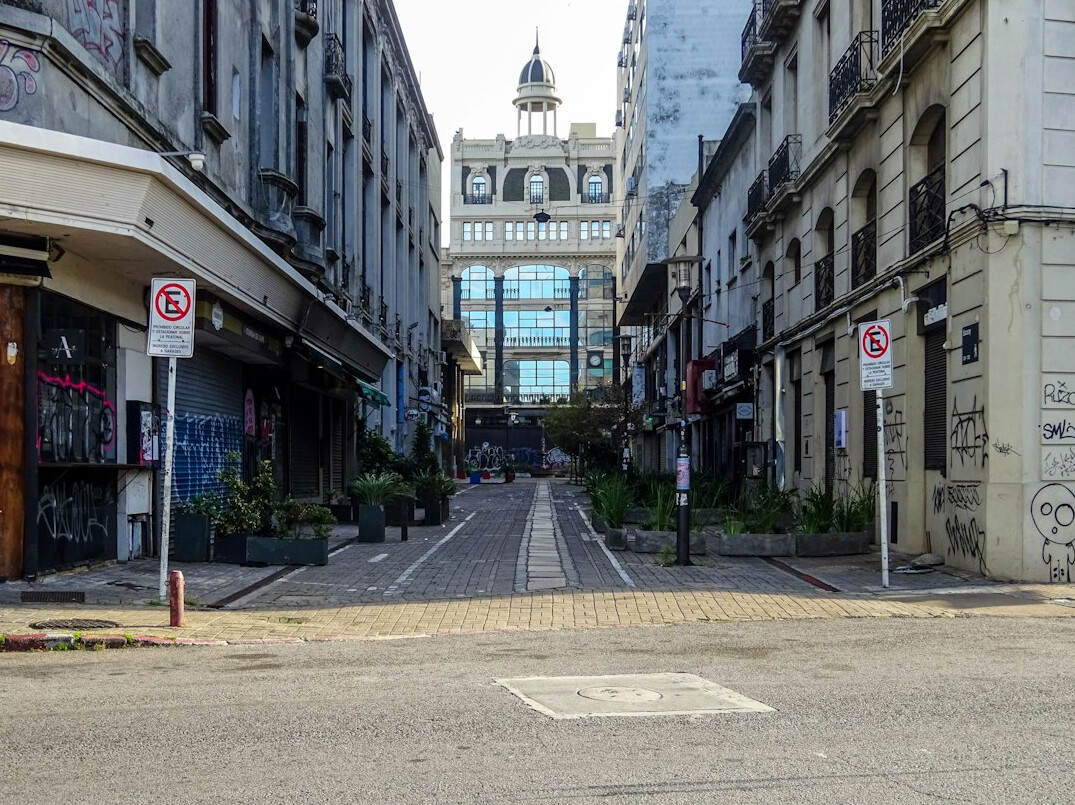 Old cobblestone street in Ciudad Vieja Montevideo at dusk with warm streetlights